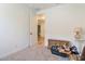 Storage or guest bedroom features a storage chest and an open doorway at 28065 N 171St Dr, Surprise, AZ 85387