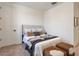 Cozy bedroom featuring a padded headboard, neutral color palette, and soft carpet at 28065 N 171St Dr, Surprise, AZ 85387