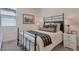 This comfortable bedroom features a metal bed frame with wood accents and a neutral color scheme at 28065 N 171St Dr, Surprise, AZ 85387