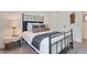 Comfortable bedroom with a dark metal bed frame and a neutral color scheme at 28065 N 171St Dr, Surprise, AZ 85387