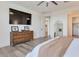 Bright bedroom with light wood floors, dresser with pictures and ensuite bathroom access at 28065 N 171St Dr, Surprise, AZ 85387