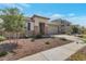 Single-story home with desert landscaping, stone accents, and a two-car garage at 28065 N 171St Dr, Surprise, AZ 85387