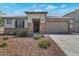 Charming single-story home features desert landscaping, stone accents, and a two-car garage at 28065 N 171St Dr, Surprise, AZ 85387