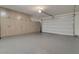 Attached garage featuring an epoxy floor, storage cabinets, and overhead lighting at 28065 N 171St Dr, Surprise, AZ 85387