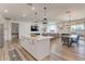 Open-concept kitchen with island, stainless steel appliances, and dining area at 28065 N 171St Dr, Surprise, AZ 85387