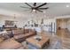 Open-concept living space featuring a large sofa, center island, and modern stainless steel appliances at 28065 N 171St Dr, Surprise, AZ 85387