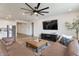 Comfortable living room with dark wood entertainment center, large TV and open layout at 28065 N 171St Dr, Surprise, AZ 85387