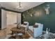 Living room with decorative wall, seating and wood flooring at 28065 N 171St Dr, Surprise, AZ 85387