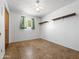 Bright bedroom featuring a ceiling fan, a window with curtains, and built-in shelving at 2834 E Michael Dr, Phoenix, AZ 85032