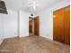A bright bedroom featuring a ceiling fan and an open doorway to another room at 2834 E Michael Dr, Phoenix, AZ 85032
