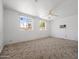 Large bedroom with bright windows, neutral carpet, and an air conditioning unit at 2834 E Michael Dr, Phoenix, AZ 85032