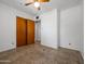 This is a bedroom with neutral carpet, white walls, and wood closet doors at 2834 E Michael Dr, Phoenix, AZ 85032