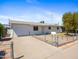 This is a exterior view of the house showing the front yard, driveway, and white exterior at 2834 E Michael Dr, Phoenix, AZ 85032