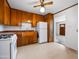 Traditional kitchen featuring wooden cabinets, a white refrigerator, and a view into the foyer at 2834 E Michael Dr, Phoenix, AZ 85032