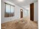 A secondary view of the living room, showing the carpet and the front door at 2834 E Michael Dr, Phoenix, AZ 85032