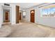 The open living room has carpet and a window looking out to the front yard at 2834 E Michael Dr, Phoenix, AZ 85032