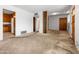 The living room has neutral carpet and paint and is open to the kitchen at 2834 E Michael Dr, Phoenix, AZ 85032