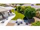 Aerial view of a backyard with a covered patio, artificial grass, patio seating, and a fire pit at 2910 S Olivewood --, Mesa, AZ 85212