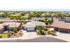 Charming aerial view of a single-story home with desert landscaping, and a three-car garage at 2910 S Olivewood --, Mesa, AZ 85212