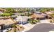 Beautiful aerial view of a single-story home featuring a three-car garage, desert landscaping, and a prime location at 2910 S Olivewood --, Mesa, AZ 85212