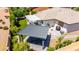This aerial view showcases a backyard with a patio, picnic table, covered patio, and low-maintenance landscaping at 2910 S Olivewood --, Mesa, AZ 85212
