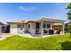 Well-maintained backyard featuring a covered patio and artificial turf at 2910 S Olivewood --, Mesa, AZ 85212
