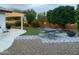 Beautiful backyard with patio area, lush landscaping, and outdoor lighting at 2910 S Olivewood --, Mesa, AZ 85212
