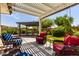 Inviting backyard with a pergola-covered seating area and lush greenery at 2910 S Olivewood --, Mesa, AZ 85212