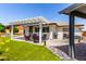 This backyard features a covered patio area with outdoor seating and a well-maintained artificial lawn at 2910 S Olivewood --, Mesa, AZ 85212