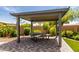This backyard patio features a covered picnic table area with pavers and low-maintenance landscaping at 2910 S Olivewood --, Mesa, AZ 85212