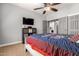 Comfortable bedroom with TV, ceiling fan and access to the laundry room at 2910 S Olivewood --, Mesa, AZ 85212