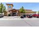 Community clubhouse with parking for golf carts in a well-maintained area under a clear blue sky at 2910 S Olivewood --, Mesa, AZ 85212