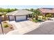 Charming single-story home featuring a three-car garage, well-maintained landscaping, and a beautiful palm tree in the front yard at 2910 S Olivewood --, Mesa, AZ 85212
