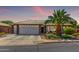 Charming single-story home featuring a two-car garage and desert landscaping at 2910 S Olivewood --, Mesa, AZ 85212