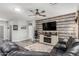 Cozy living room featuring a decorative fireplace, ceiling fan, and modern decor at 2910 S Olivewood --, Mesa, AZ 85212