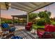 Inviting covered patio with comfortable seating and a view of the landscaped backyard, perfect for outdoor relaxation at 2910 S Olivewood --, Mesa, AZ 85212