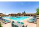 Community pool with plenty of lounge chairs and tables, perfect for enjoying sunny days and socializing at 2910 S Olivewood --, Mesa, AZ 85212