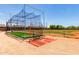 Modern training facility with artificial turf and protective netting, providing a safe practice area at 2910 S Olivewood --, Mesa, AZ 85212