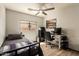 Relaxing bedroom with a desk, ceiling fan, and stylish decor at 3032 W Red Fox Rd, Phoenix, AZ 85083