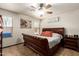 Cozy bedroom with a large bed, ceiling fan and bright windows, perfect for rest and relaxation at 3032 W Red Fox Rd, Phoenix, AZ 85083