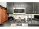 Stylish kitchen with gas range, granite countertops, and stainless steel microwave, perfect for cooking at 3032 W Red Fox Rd, Phoenix, AZ 85083
