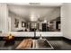 Open concept kitchen with view into living room, featuring a modern faucet and deep stainless steel sink at 3032 W Red Fox Rd, Phoenix, AZ 85083