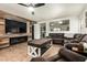 Cozy living room features a fireplace, a ceiling fan and comfortable seating for relaxation and entertainment at 3032 W Red Fox Rd, Phoenix, AZ 85083