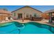Beautiful backyard oasis with a swimming pool and patio area at 3032 W Red Fox Rd, Phoenix, AZ 85083