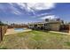 Spacious backyard featuring a pool, covered patio, and green lawn for outdoor enjoyment at 308 E La Jolla Dr, Tempe, AZ 85282