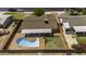Aerial view of a backyard featuring a uniquely shaped pool, covered patio, and well-maintained fencing at 308 E La Jolla Dr, Tempe, AZ 85282