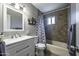 Well-lit bathroom featuring a shower-tub combo, white vanity, and decorative cactus accent at 308 E La Jolla Dr, Tempe, AZ 85282