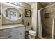 Well-lit bathroom with tiled shower, modern fixtures, and a granite countertop at 308 E La Jolla Dr, Tempe, AZ 85282