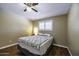 Cozy bedroom with wood floors, ceiling fan, and a window with white shutters at 308 E La Jolla Dr, Tempe, AZ 85282