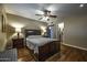 Comfortable main bedroom with wood floors, ceiling fan, and ensuite bathroom access at 308 E La Jolla Dr, Tempe, AZ 85282
